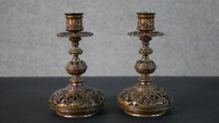 A pair of 19th century pierced foliate and floral design bronze candle sticks. H.30 W.16 D.12cm