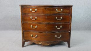 A George III style mahogany serpentine chest, the top crossbanded in satin birch, on four long