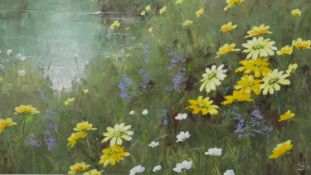 A framed oil on canvas of a wild flower meadow, indistinctly signed. H.63.5 W.63.5cm