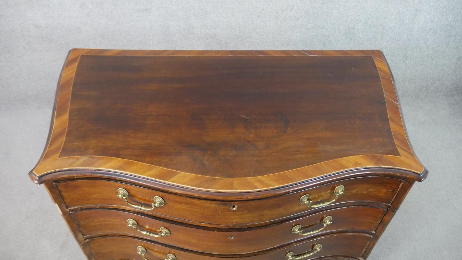 A George III style mahogany serpentine chest, the top crossbanded in satin birch, on four long - Image 4 of 9