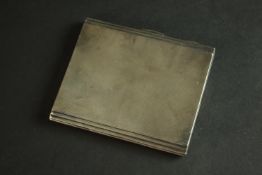 An engine turned silver cigarette case with gilded interior and rectangular cartouche. Hallmarked:
