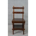 A mahogany metamorphic library chair, the double bar back with applied chamfered detail,