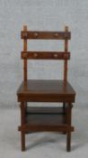 A mahogany metamorphic library chair, the double bar back with applied chamfered detail,
