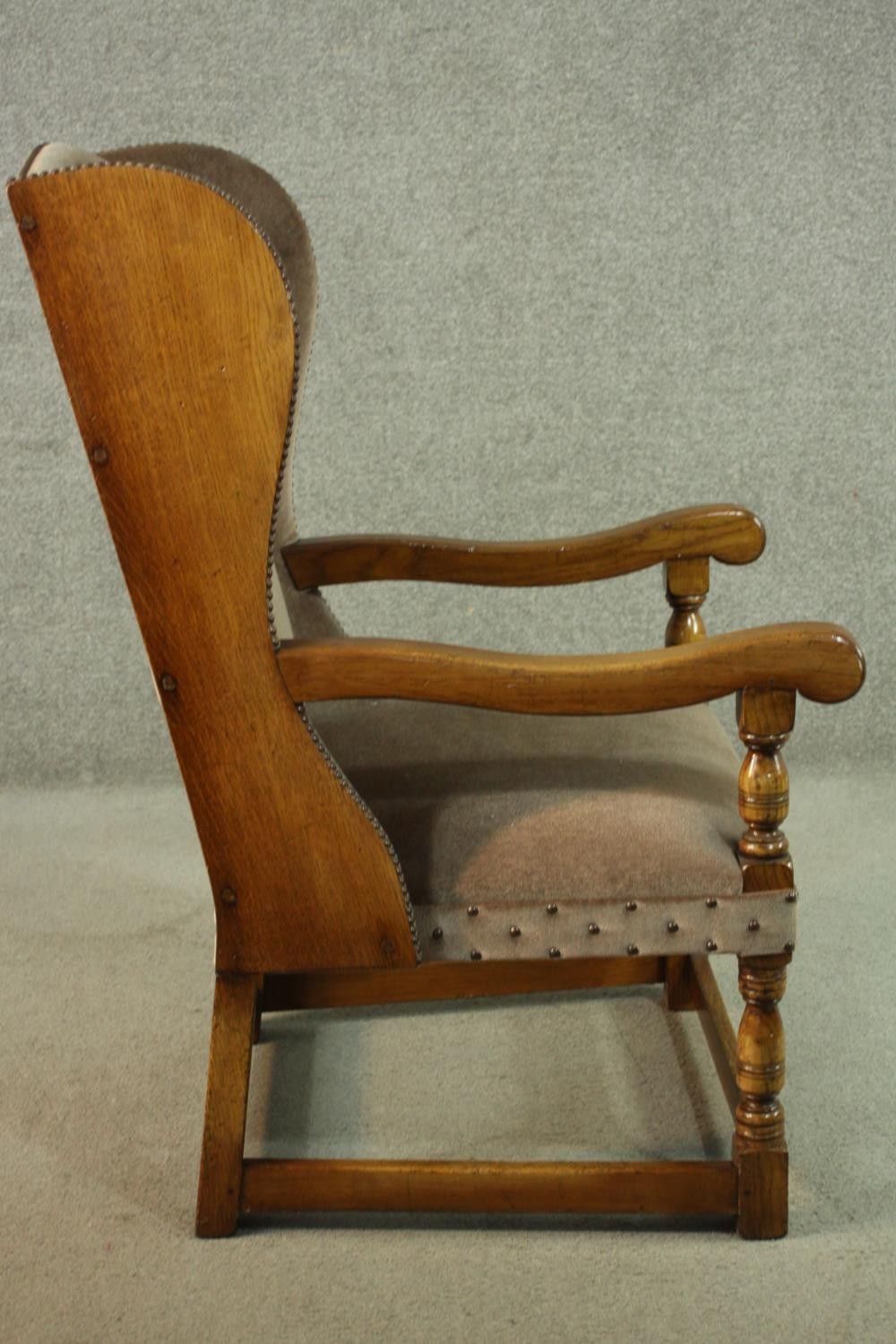 An oak wainscot style wingback armchair, upholstered in brown velour with studded detail, with - Image 3 of 7