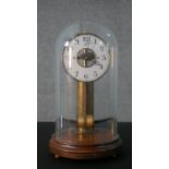 An early 20th century Maurice Favre - Boulle electric pendulum clock, in a glass and mahogany
