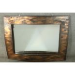 A contemporary copper framed mirror, of rectangular form, with a lattice design undulating frame.