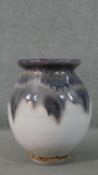 A large purple drip glaze on white ground art pottery vase. Impressed number to base. H.47 Diam.30cm