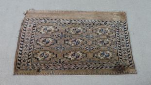 A tan ground fine handmade Turkman saddle bag. L.113 W.73cm