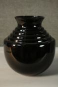 A Calligaris black glass stepped design vase, makers mark to the base. H.30 Dia.23cm.