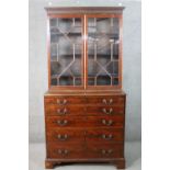 A Chippendale style mahogany secretaire bookcase, with a blind fret cornice over a pair of