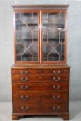 A Chippendale style mahogany secretaire bookcase, with a blind fret cornice over a pair of