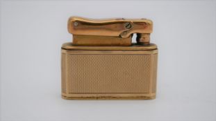 A 9ct yellow gold cased Colibri Monopol lighter, with engine turned decoration and cartouche
