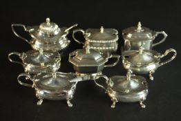Eight sterling silver hinged lid mustard pots, various designs, makers and assay marks. Some with