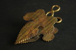 A 19th century damascene sprung letter clip in the form of an ivy leaf with serrated edges. L.9 W.