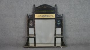 A Victorian Aesthetic movement overmantel mirror, ebonised, with a pierced frieze, over a gilt panel