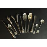 A collection of silver, including a berry spoon, glove stretchers, three boot hooks and various