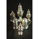 A Collection of four silver pepper shakers, a silver sugar sifter with floral swag design and a