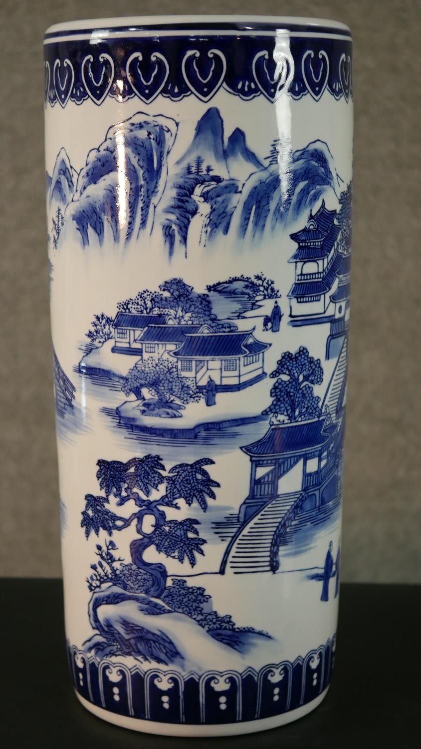 A 20th century blue and white Chinese porcelain stick stand decorated with a mountain landscape, - Image 3 of 9