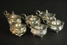Six sterling silver hinged lid mustard pots, various designs, makers and assay marks. Weight.376g.