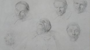 A framed and glazed print of a pencil drawing with various studies of male faces with different