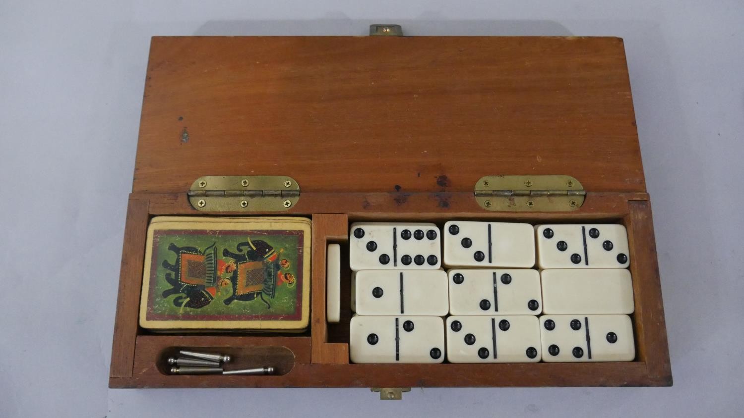 An early 20th century games box, with dominoes, cards and a cribbage set along with a marquetry - Image 5 of 6