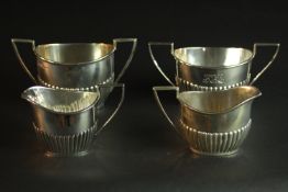 A collection of silver by Walker & Hall, including two silver gadrooned design milk jugs and two