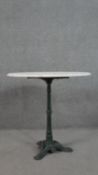 A cast iron bistro table, the circular marble top with a moulded edge, the painted base on tripod