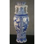 A large blue and white Chinese porcelain twin handled vase, one side decorated with a river scene
