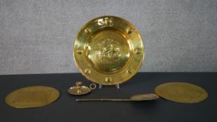 A collection of brass ware, including two arts and crafts brass plaques, a Victorian brass slotted