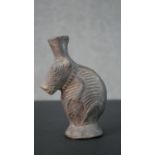 A pre-Colombian style clay vase in the form of an armadillo with relief design. H.16 W.11cm
