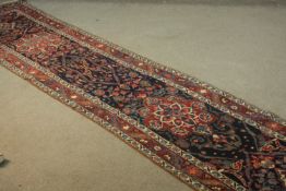 A Persian Heriz blue ground hand made runner. L.356 W.70cm.