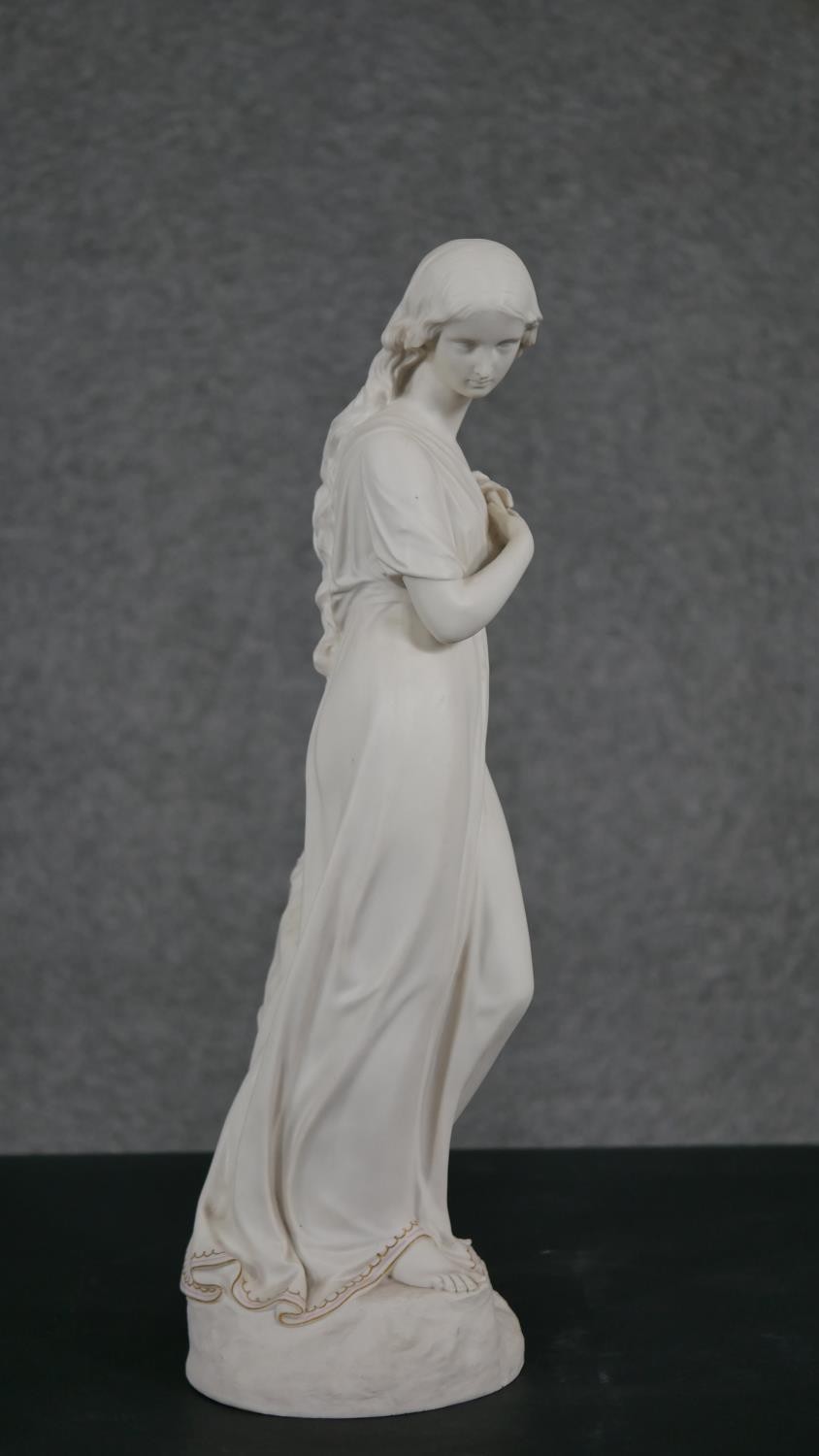 A Copeland Parian ware figure of a girl standing holding a flower to her breast, gilt border to - Image 2 of 12