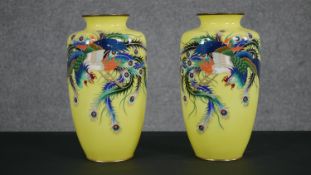 A pair of Meji period Japanese cloisonné enamel vases. Each with Phoenix's on yellow ground. H.31