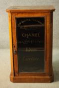A 19th century burr walnut and satinwood strung pier cabinet with later painted Chanel, Dior and
