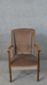 A circa 1940's beech armchair, upholstered in brown velour, open armed, with shaped supports.