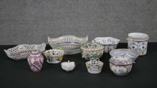 A collection of Dresden hand painted porcelain, including flower baskets, trinket dishes, lidded