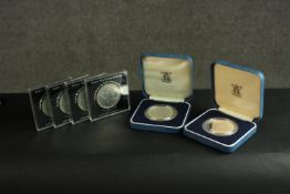 A collection of six commemorative coins. Two with cases and certificates. (1)