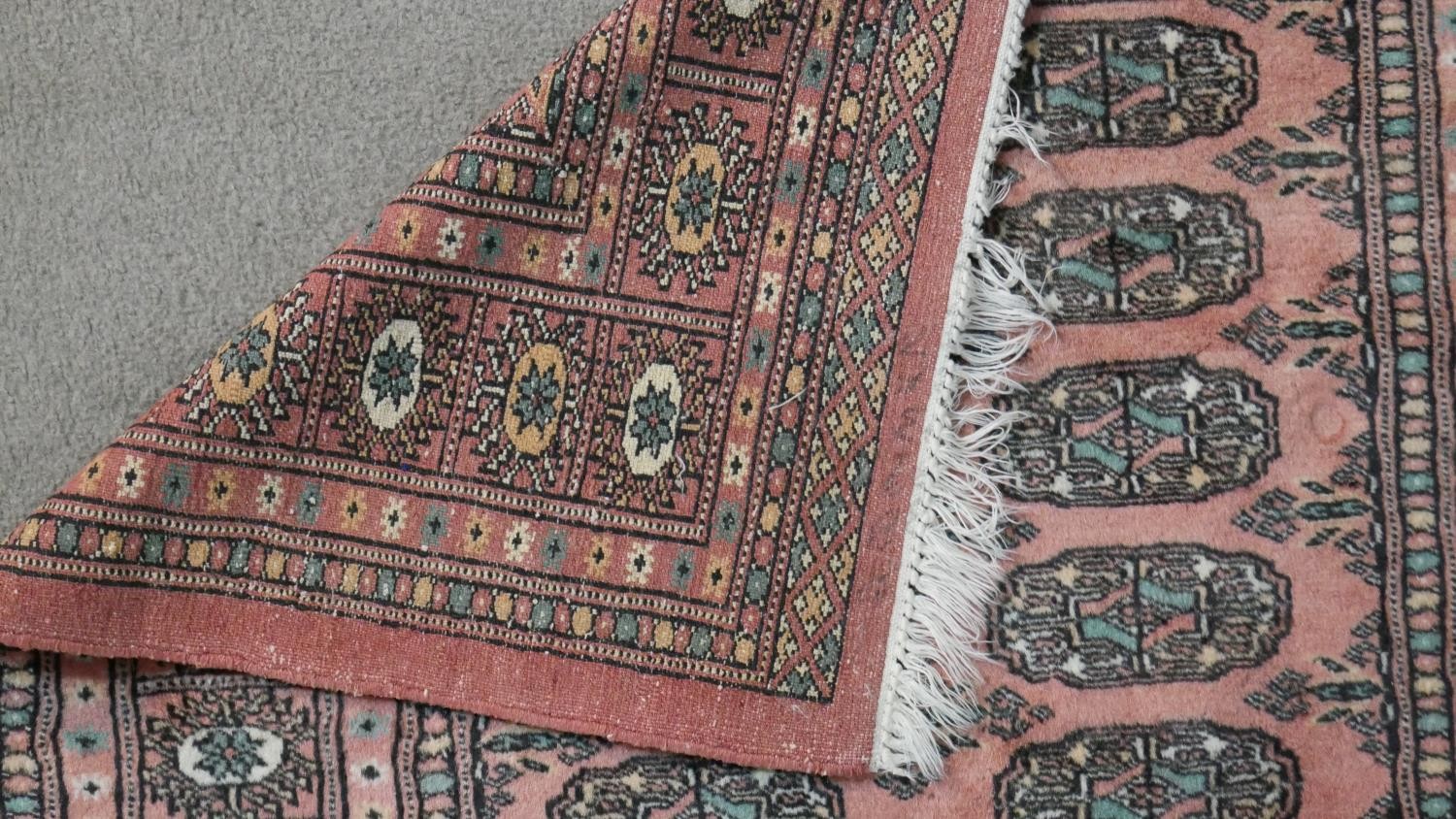 A rose ground handmade Pakistan Bokhara rug. L.150 W.100cm - Image 5 of 6