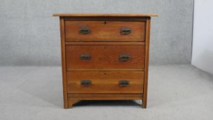 An Arts & Crafts oak chest, the overhanging rectangular top over three long drawers, on shaped
