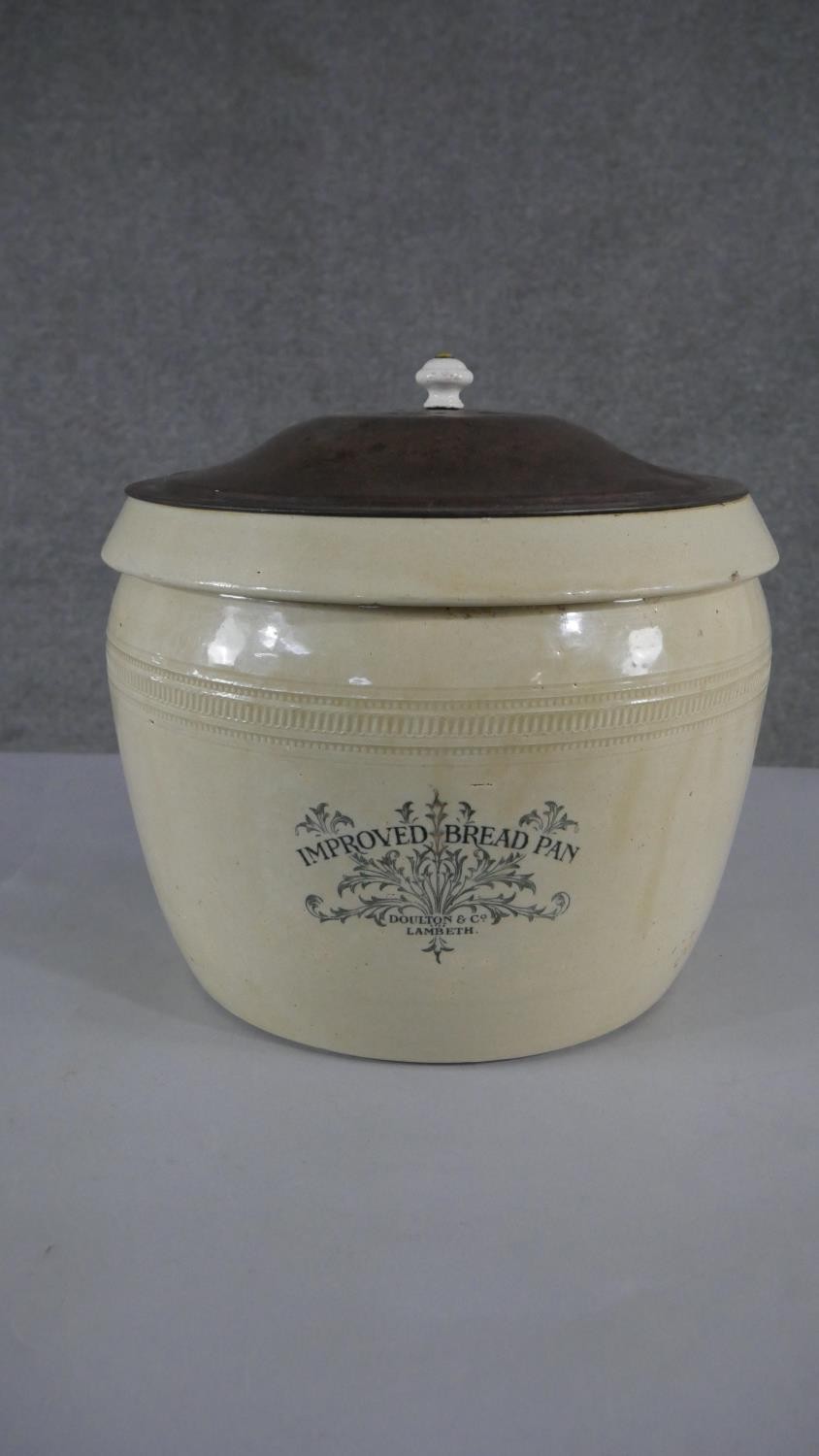 A large Victorian Stoneware bread pan, named Doulton Lambeth & Co, with metal lid and ceramic