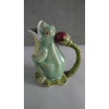 A Majolica glazed pitcher in the form of a gaping frog with waterlily bud handle, stamped to the