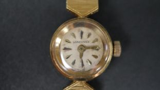A ladies vintage 18 carat yellow gold watch by Longines, with textured tapered bracelet, stamped