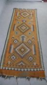 An Afghan Kelim rust ground hand made runner. L.220 W.80cm