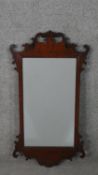 A George III style mahogany fretwork mirror, of typical design, with a rectangular mirror plate. H.