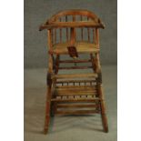 A Victotrian simulated bamboo metamorphic child's high chair, with a spindle back and caned seat, on