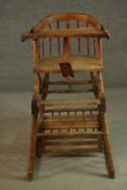 A Victotrian simulated bamboo metamorphic child's high chair, with a spindle back and caned seat, on