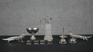 A collection of mixed silver plate, including a wine funnel, two butter dishes, four candle holders,