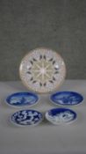 A collection of porcelain plates, including Royal Copenhagen blue and white commemorative plates and