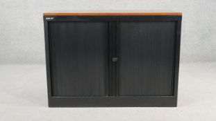 A Bisley tambour front seccurity cabinet, with a fruitwood top, and a black powder coated metal