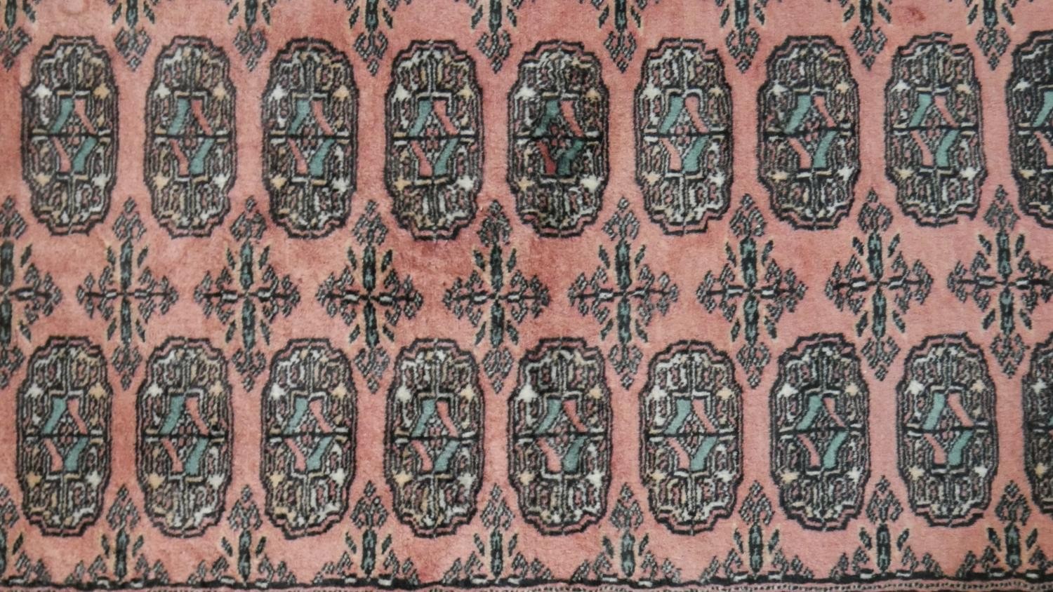 A rose ground handmade Pakistan Bokhara rug. L.150 W.100cm - Image 3 of 6